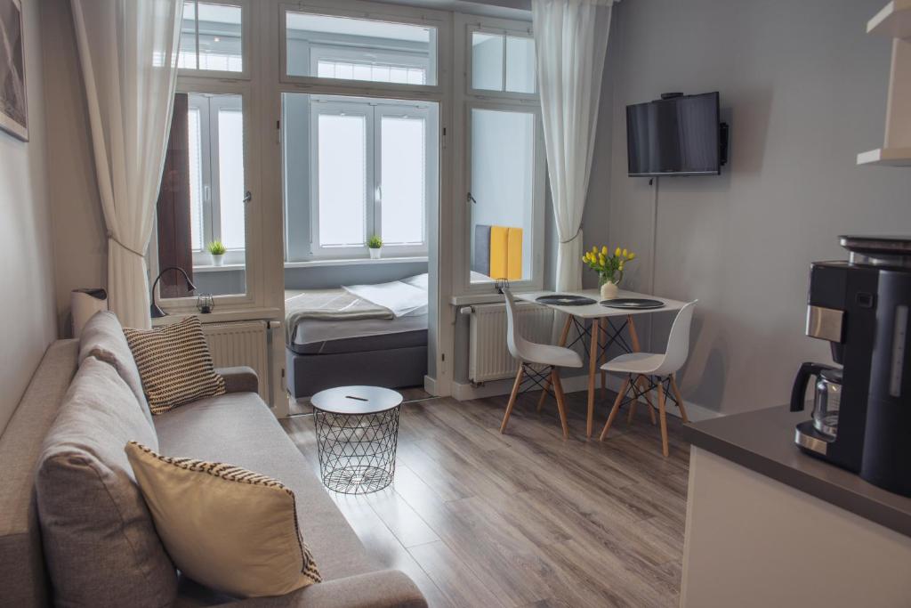 a small living room with a couch and a table at Apartment Gaja in Karpacz