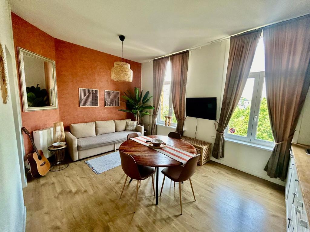 a living room with a table and a couch at SLEEP INN - Arizona flat with cityview in Antwerp