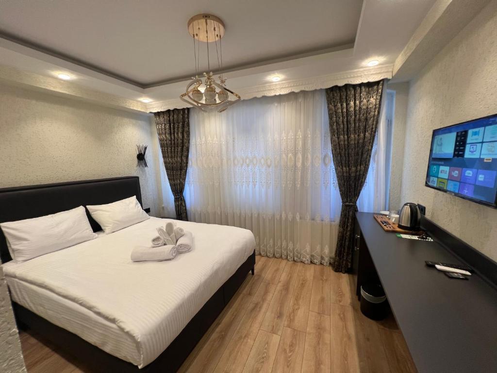Postel nebo postele na pokoji v ubytování Feycem Suites Hotel