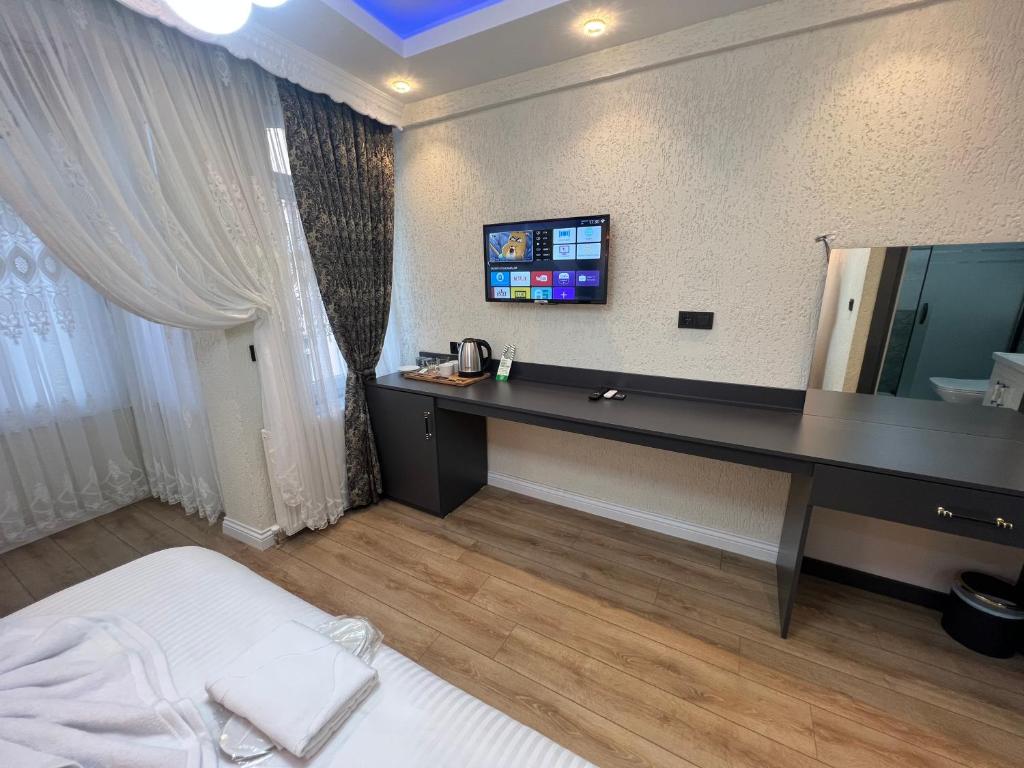 Postel nebo postele na pokoji v ubytování Feycem Suites Hotel