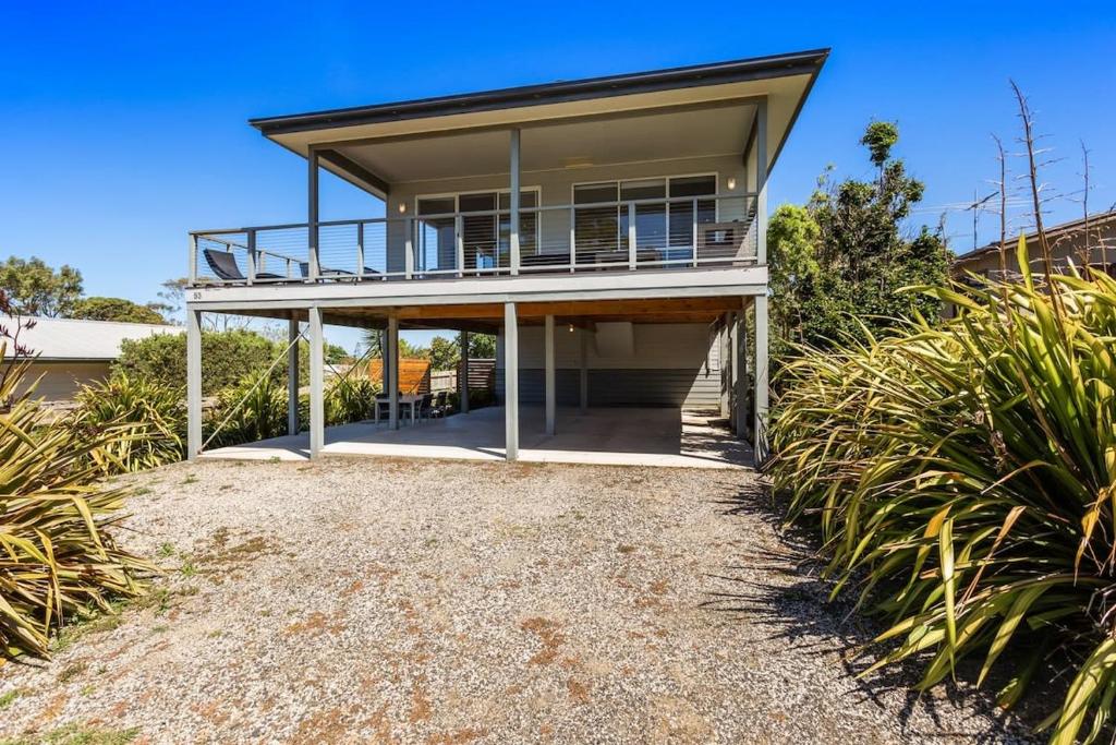 a house on the beach with a balcony at Ocean View Escape w 3BR & 2BA in Rhyll