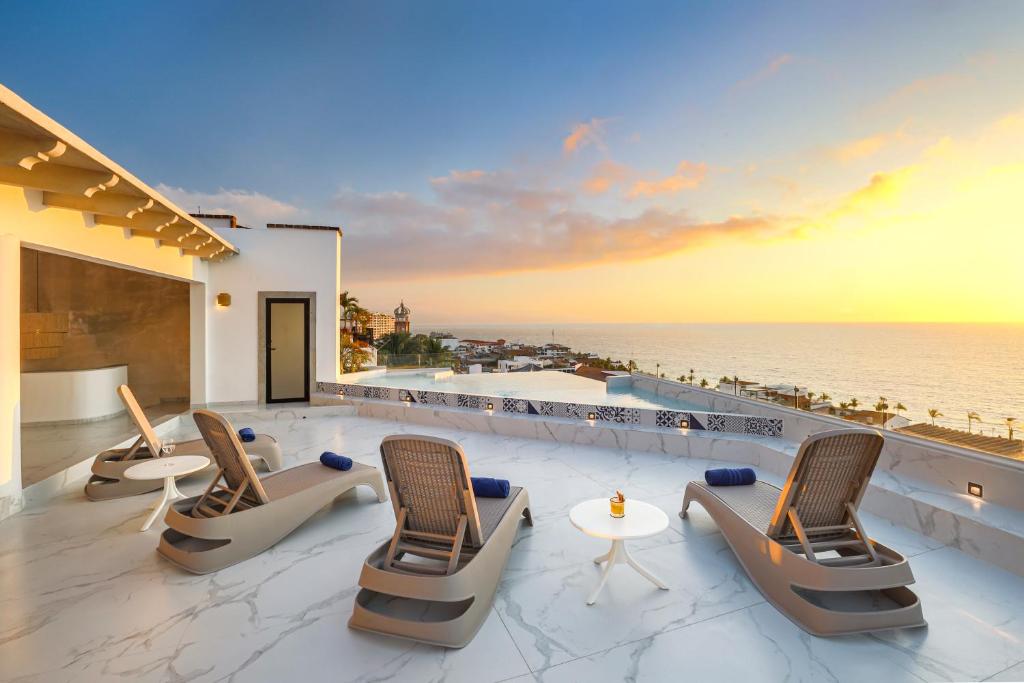 d'une terrasse avec des chaises et une vue sur l'océan. dans l'établissement Casa Nawalli Puerto Vallarta Boutique Hotel - Adults Only, à Puerto Vallarta