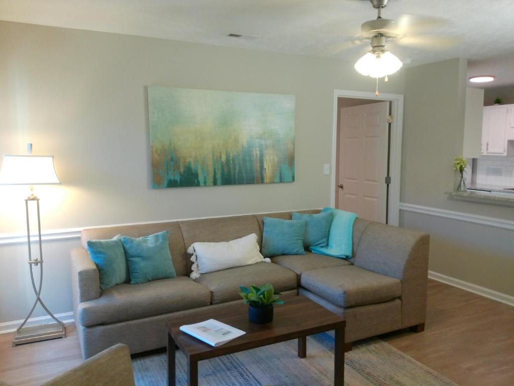 a living room with a couch and a table at Fayetteville Studio 415 in Spring Lake