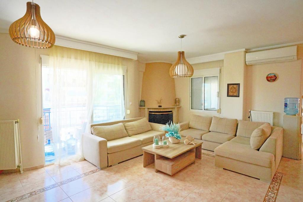 a living room with two couches and a coffee table at LOVELY AND SUNNY APARTAMENT 300m FROM BEACH!! in Perea