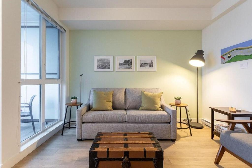 a living room with a couch and a table at Urban Stay With Balcony And In-Unit Laundry in Victoria