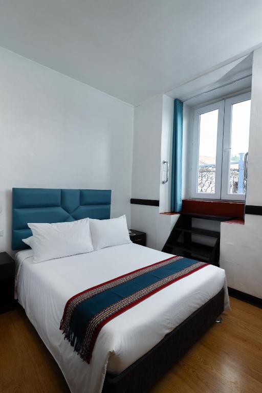 Postel nebo postele na pokoji v ubytování Hotel Hacienda Cusco Plaza