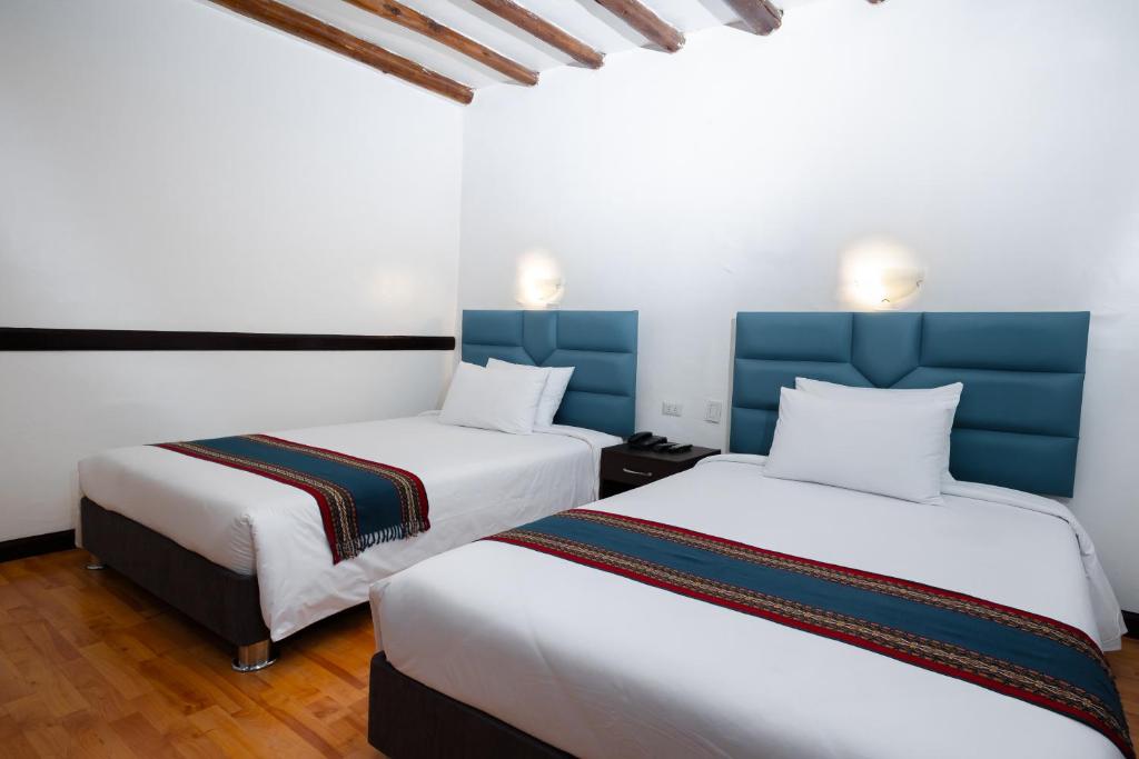 Postel nebo postele na pokoji v ubytování Hotel Hacienda Cusco Plaza