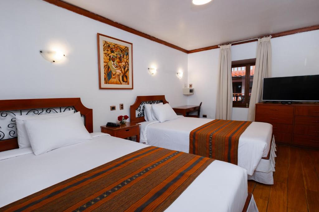 Postel nebo postele na pokoji v ubytování Hotel Hacienda Cusco Plaza