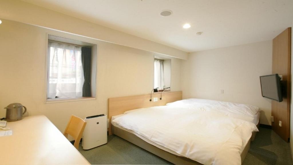 Postel nebo postele na pokoji v ubytování Ace Inn Matsumoto