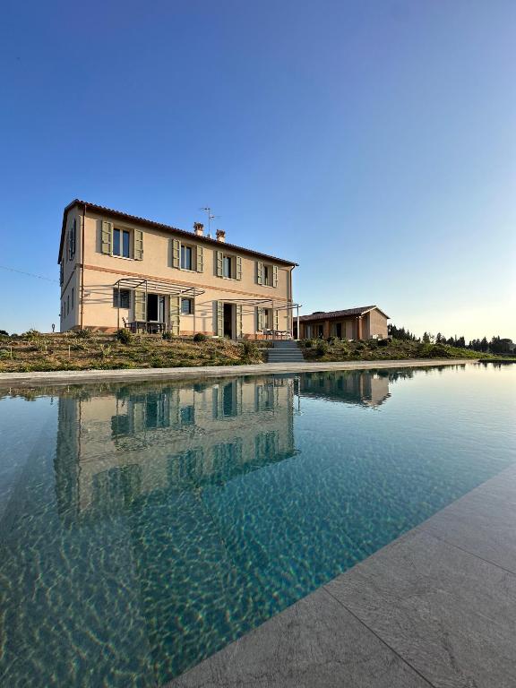 a building sitting on top of a body of water at Podere Mantignano in Faenza