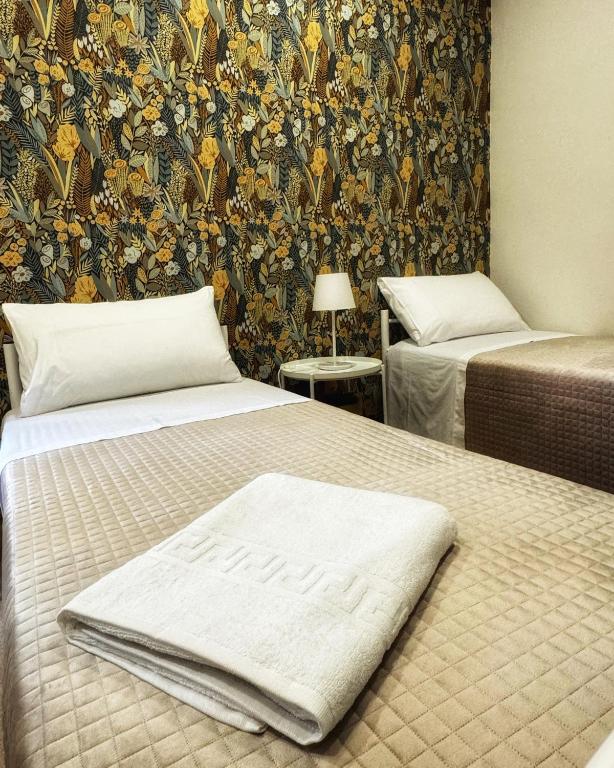 Postel nebo postele na pokoji v ubytování Sicily O'Clock Room