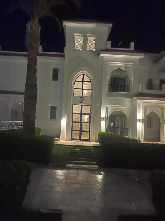 a large white house with a door at night at Neama town in Sharm El Sheikh