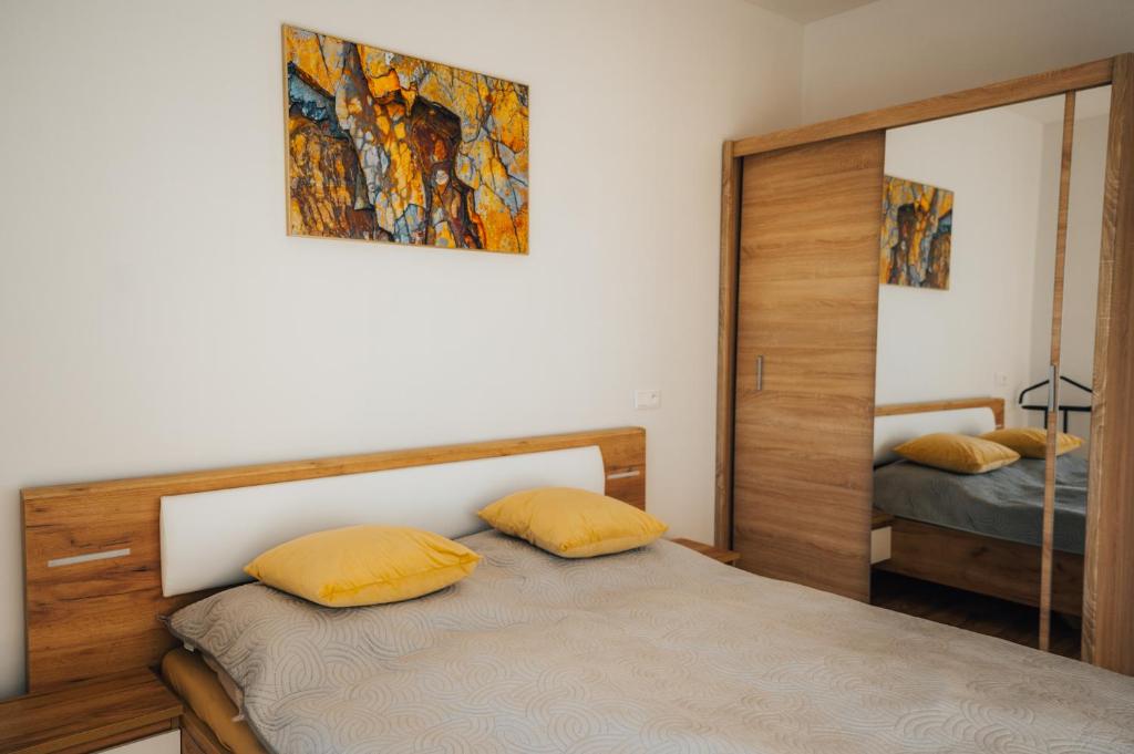 a bedroom with two beds and a mirror at Apartmány Na Vŕšku in Kežmarok