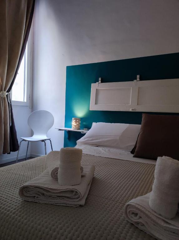a bedroom with a bed with towels on it at Fatata Suites in Lecce