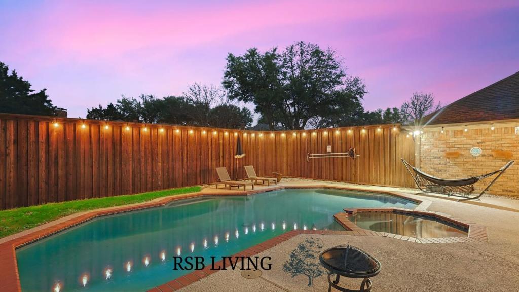 a swimming pool in a backyard with a wooden fence at Beautiful 5BR 2BA DeSoto Holiday Home with Pool in DeSoto