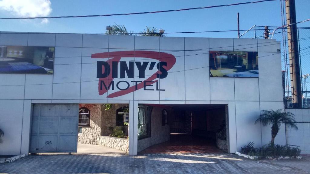 a building with a sign for a drug motel at Dinys Motel (Adults Only) in Praia Grande