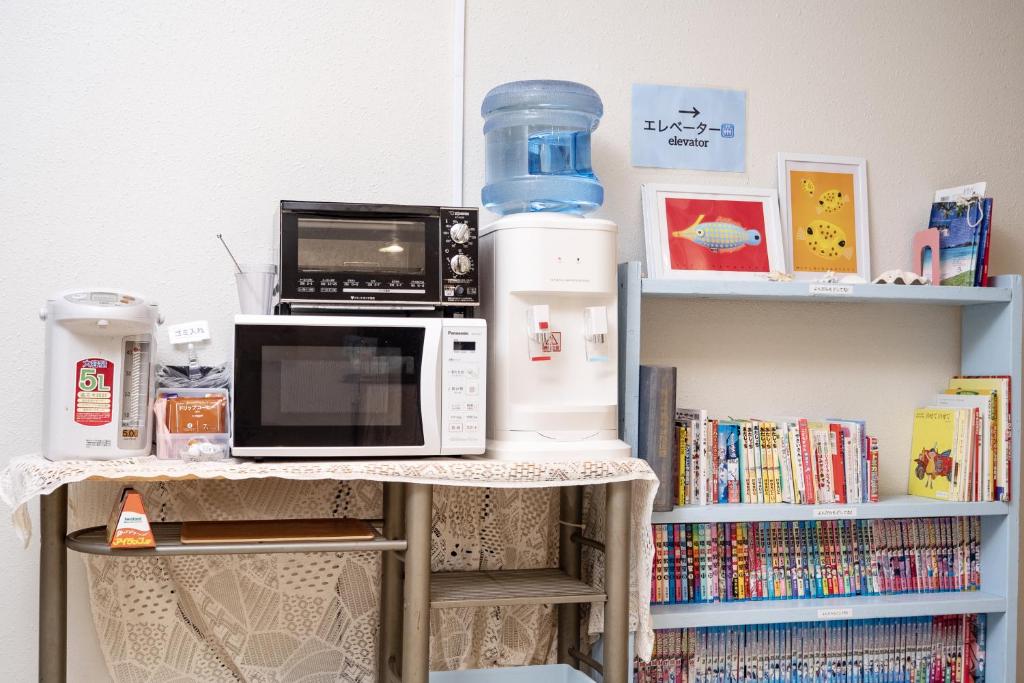 a microwave oven sitting on top of a shelf at Kerama Blue Resort in Zamami