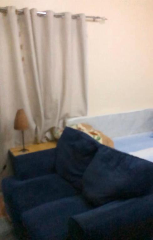 a blue couch in a living room with a curtain at استوديو in Sharjah