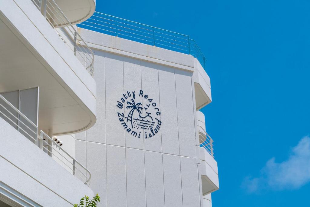 a building with a clock on the side of it at Kerama Blue Resort in Zamami