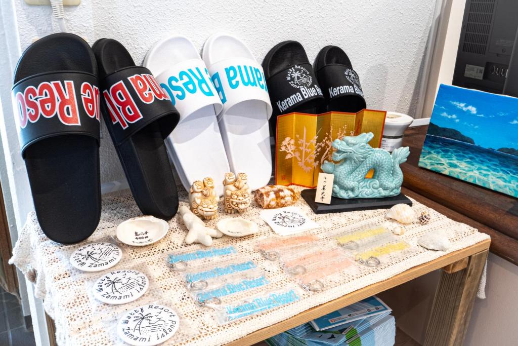 a table with flip flops and other items on it at Kerama Blue Resort in Zamami