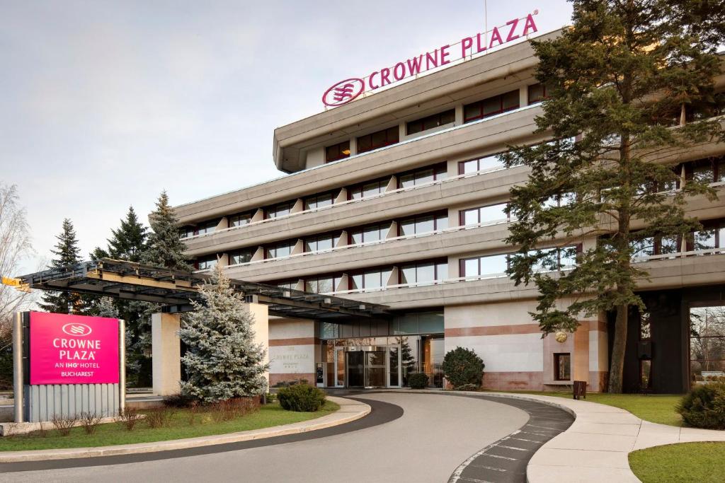 a building with a sign on the front of it at Crowne Plaza Bucharest, an IHG Hotel in Bucharest