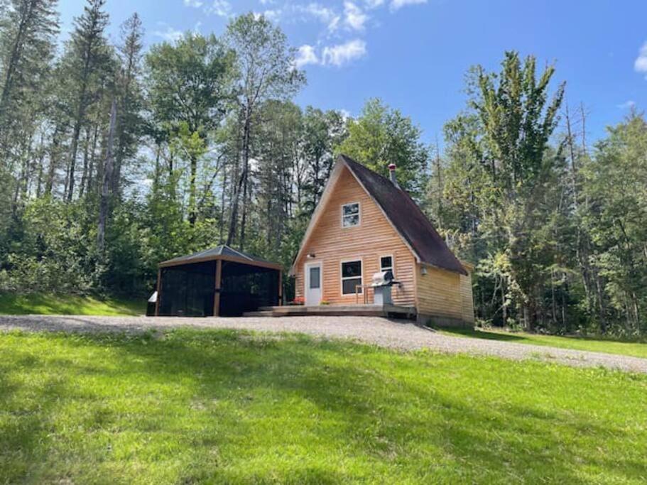 a small wooden barn with a garage at Hillside Haven 1 Bedroom with Hot Tub in Sussex