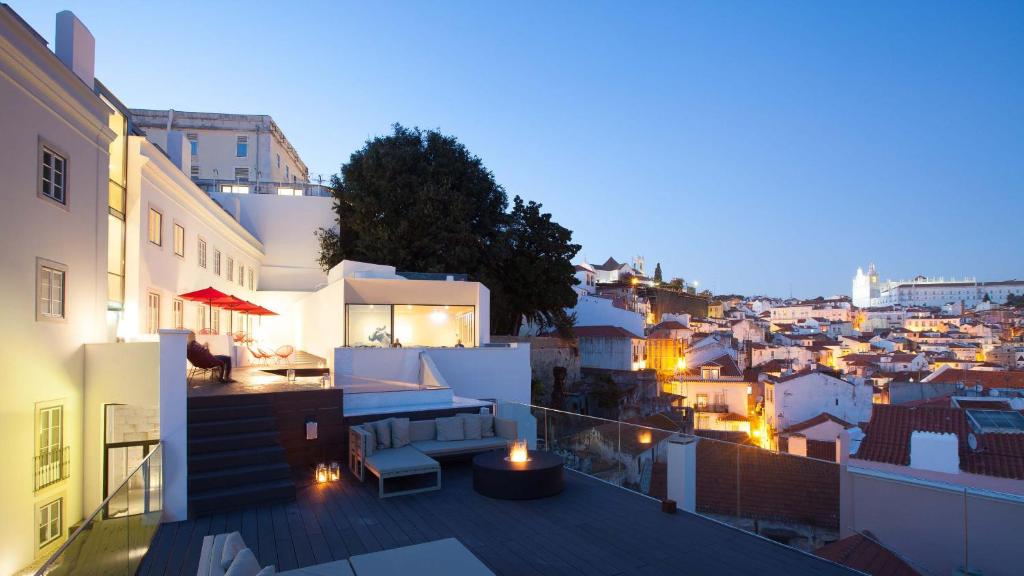 uma varanda com vista para a cidade à noite em Memmo Alfama - Design Hotels em Lisboa