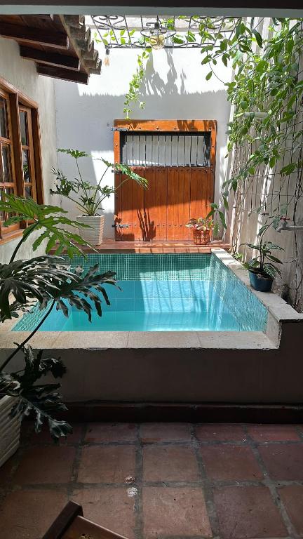 a small swimming pool in a backyard with a fence at AptoPardo1945 duplex con Jacuzzi in Mompos