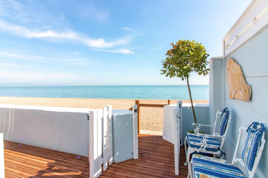 a balcony with a view of the beach at The Breakers - Riviera Apartment in Sandgate