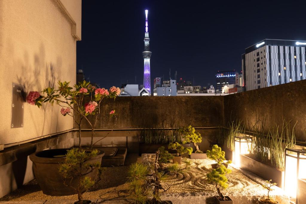 a view of the eiffel tower from a balcony at night at Ryokan Asakusa Shigetsu in Tokyo