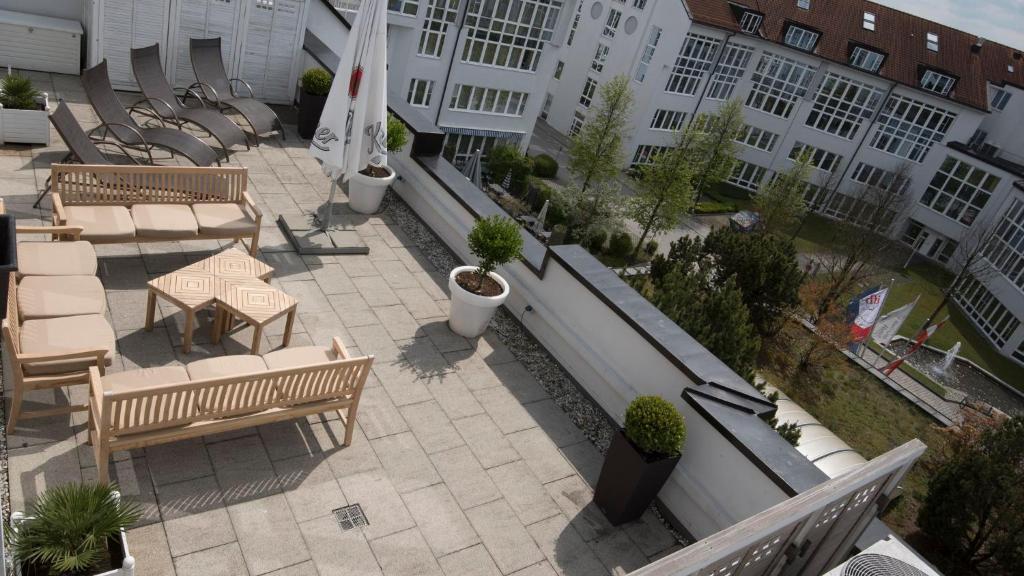 an overhead view of a patio with benches and tables at Holiday Inn Munich Unterhaching, an IHG Hotel in Unterhaching