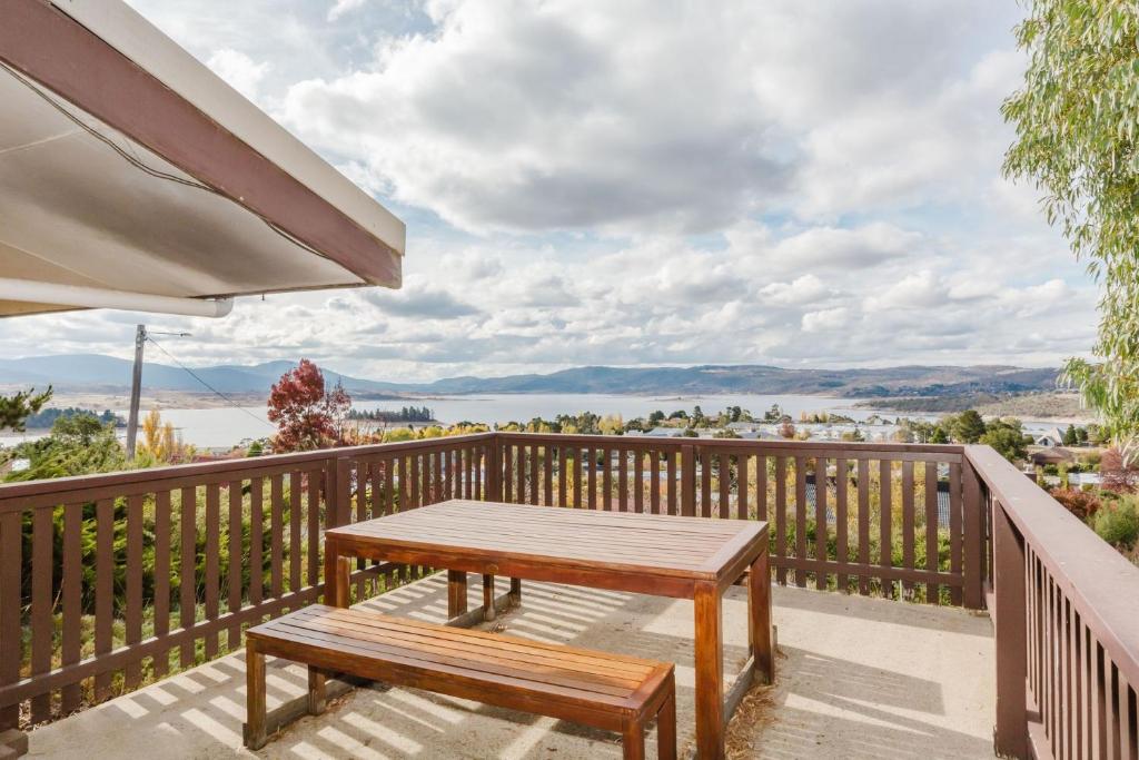 a wooden table on a balcony with a bench at Clearview 2 8 Bogong Street in Jindabyne