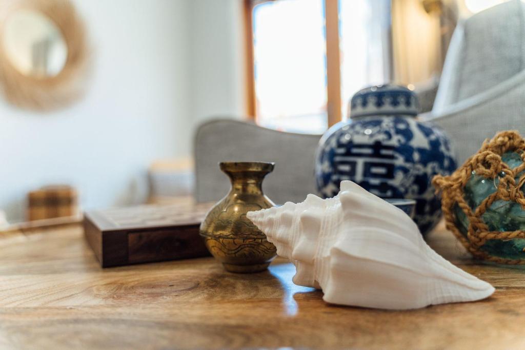 a table with vases and a napkin on it at Belle Escapes - Moseley Apartments near the beach with private garden in Glenelg