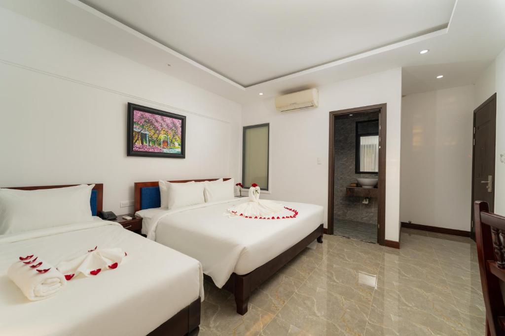 Giường trong phòng chung tại May Boutique Villa Hội An