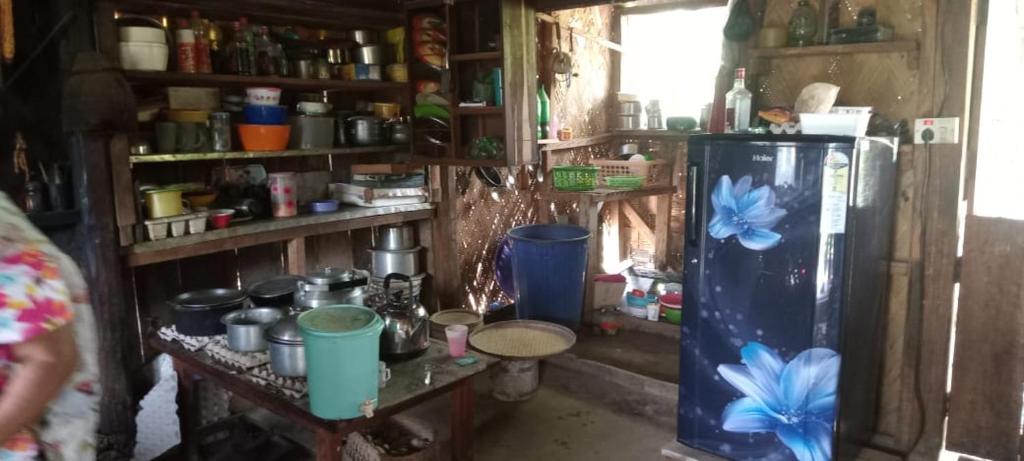 a kitchen with a refrigerator in a room at NV Medeo Homestay in Lakema
