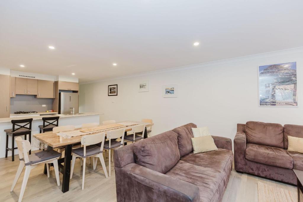 a living room with a couch and a table at Northstar 10 17 Kirwan Close in Jindabyne