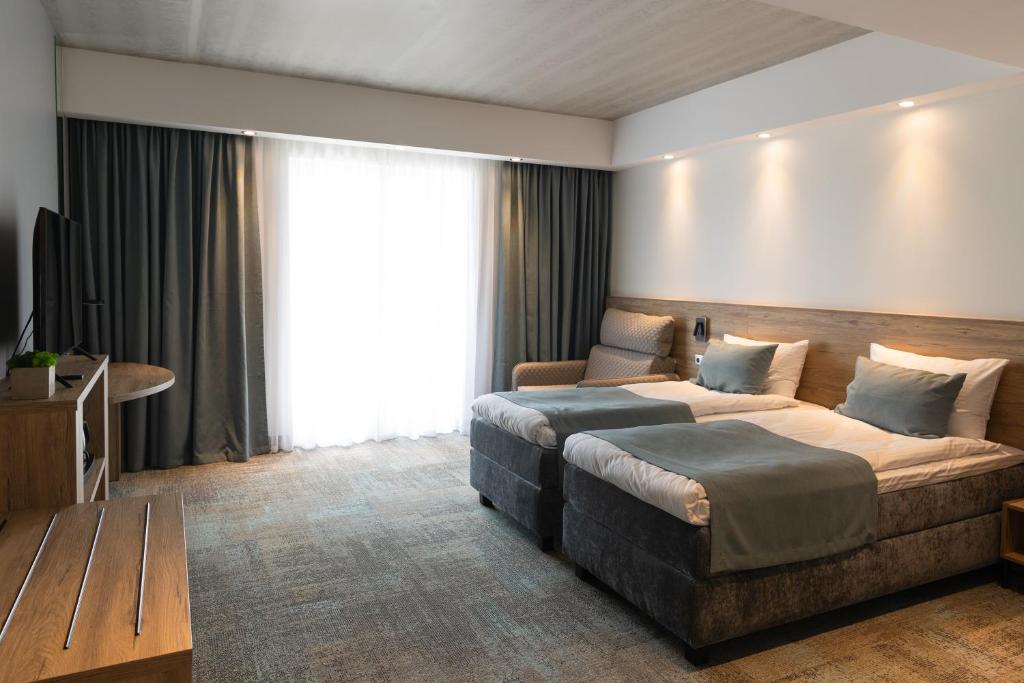 Postel nebo postele na pokoji v ubytování Molėtai Hotel