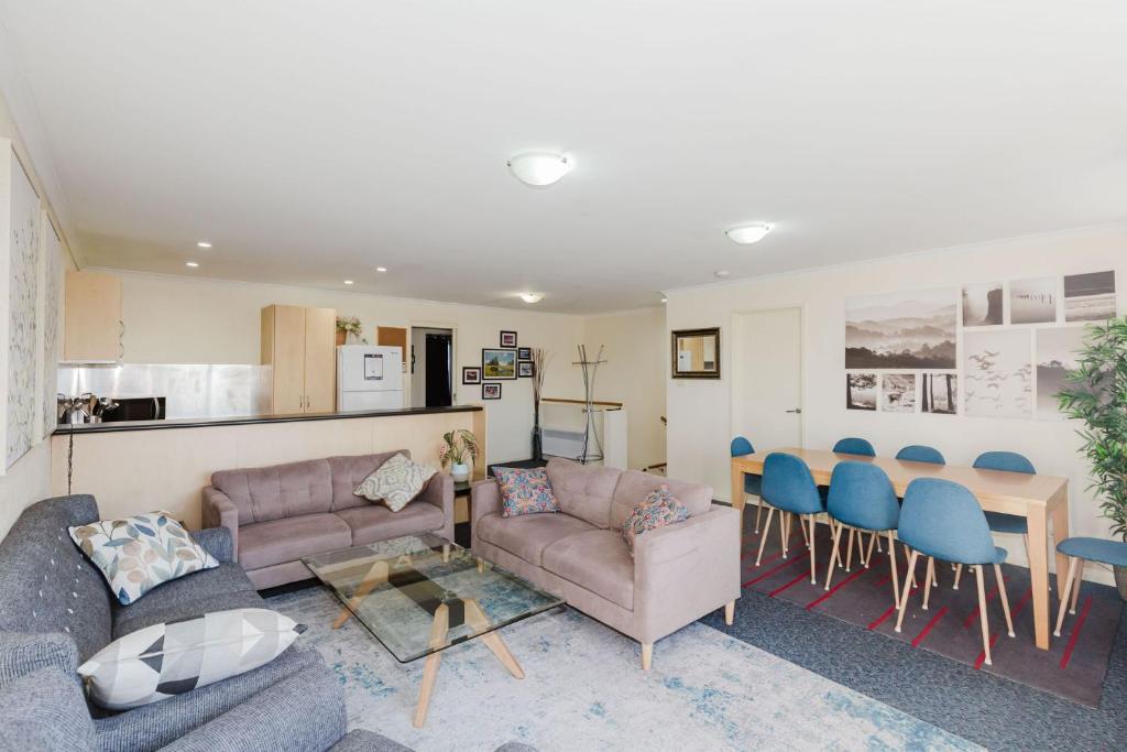 a living room with a couch and a table and chairs at Silvertrees 2 1 McLure Cir in Jindabyne