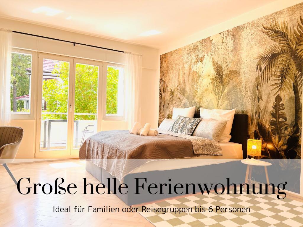 a bedroom with a bed and a large window at cardia homes Ferienwohnung Erfurt-Hopfenberg - Terrasse - Wlan - Vollausstattung in Erfurt