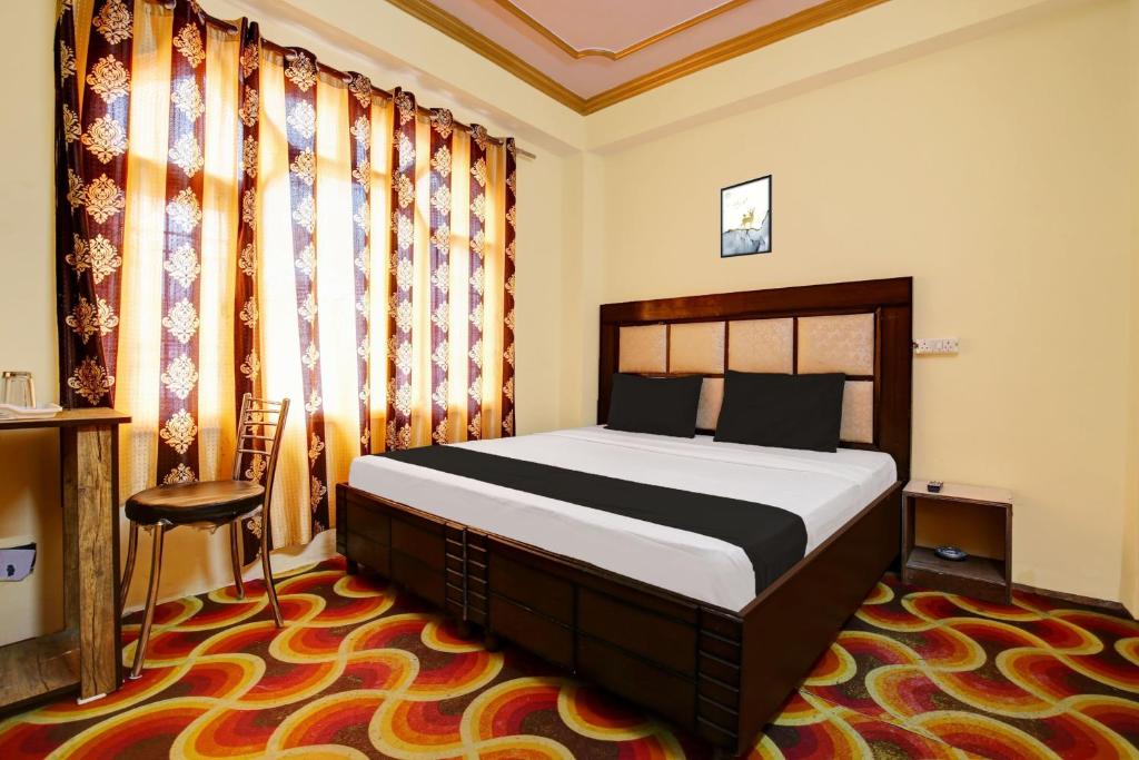 a bedroom with a bed in a room with curtains at OYO Hotel Basera in Shimla