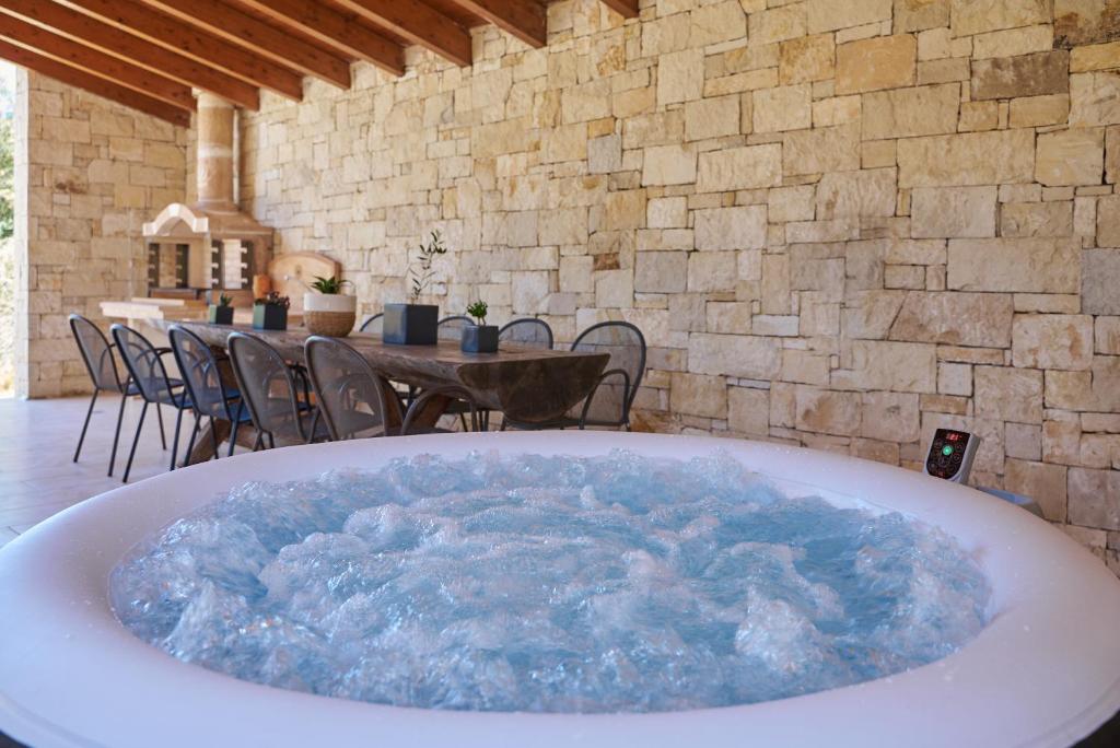 una gran bañera llena de agua azul en una habitación en Estia Project, Leisure - Billiards - Jacuzzi, en Gournes