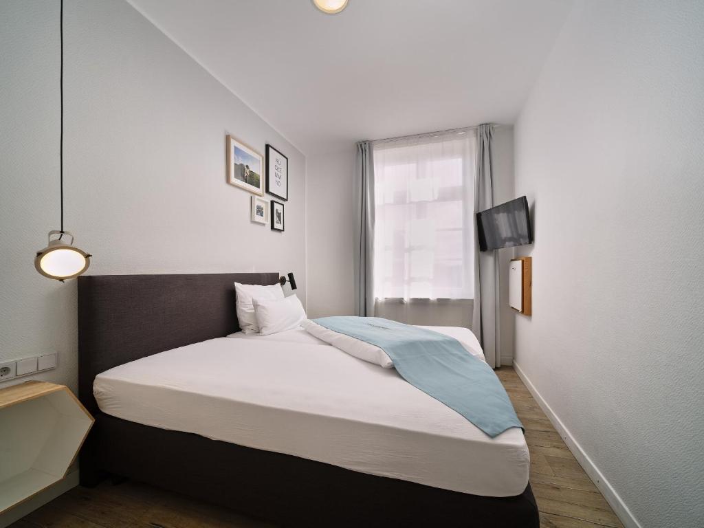 Postel nebo postele na pokoji v ubytování Hotel Siebzehn80
