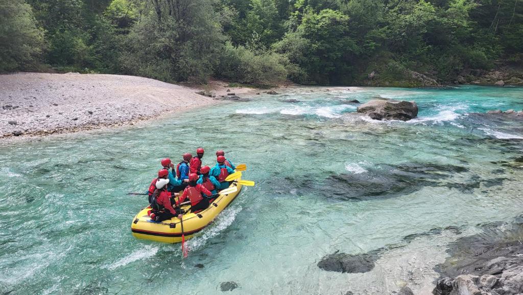 a group of people in a raft on a river at Apartment Luka at Soča & Koritnica confluence in Bovec