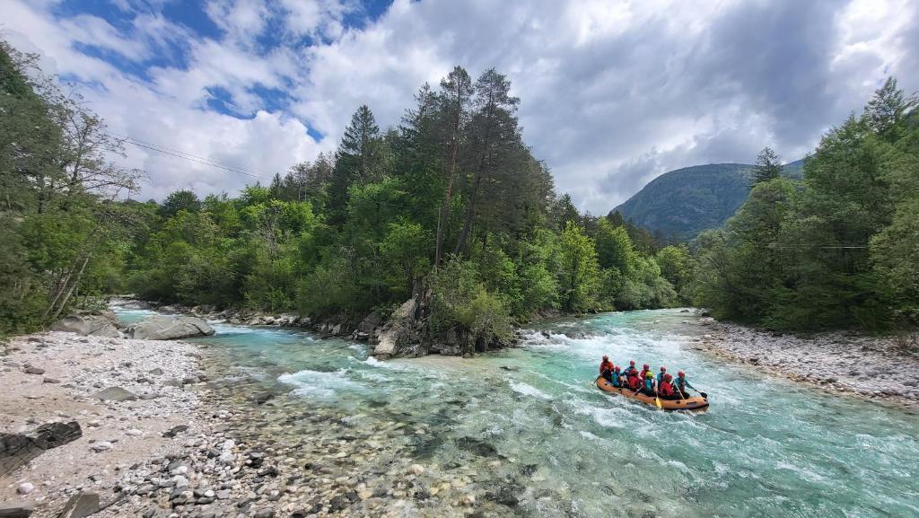 a group of people in a raft on a river at Apartment Luka at Soča & Koritnica confluence in Bovec