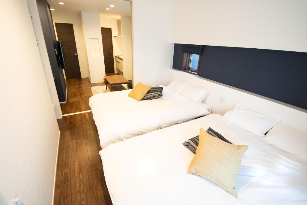 Postel nebo postele na pokoji v ubytování Apartment Hotel Tenjin TUMUGU