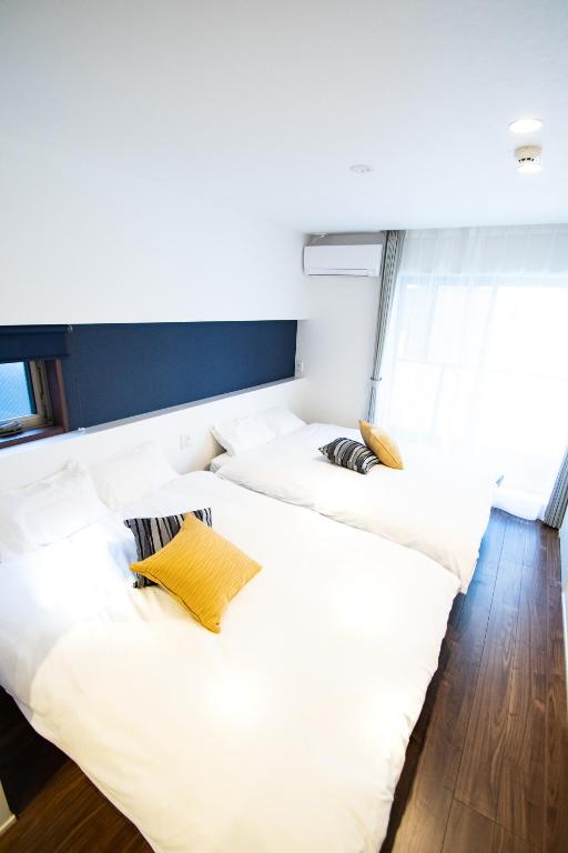 Postel nebo postele na pokoji v ubytování Apartment Hotel Tenjin TUMUGU