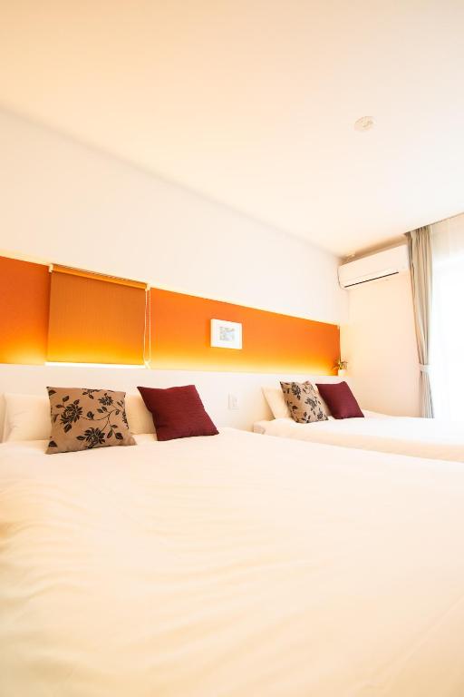 Postel nebo postele na pokoji v ubytování Apartment Hotel Tenjin TUMUGU