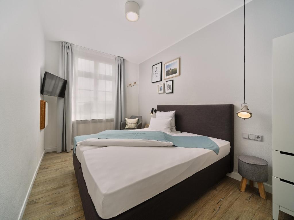 Postel nebo postele na pokoji v ubytování Hotel Siebzehn80