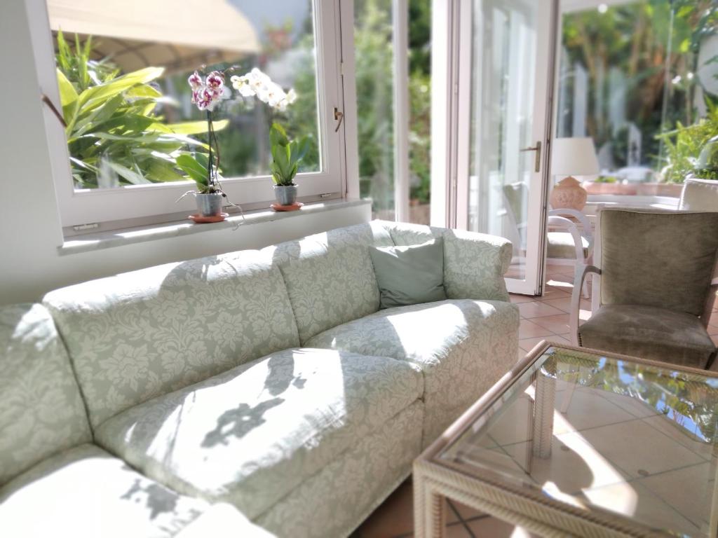 a living room with a couch and a glass table at Hotel Villa Angelica in Ischia