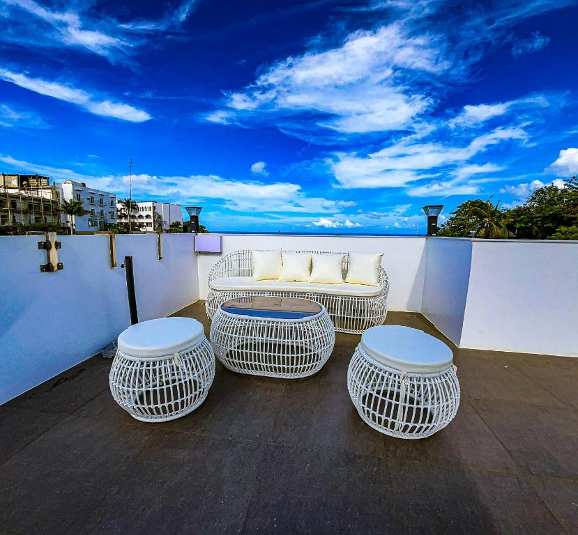 une terrasse avec un canapé, trois chaises et une table dans l'établissement The Pacific Coast, à Boracay